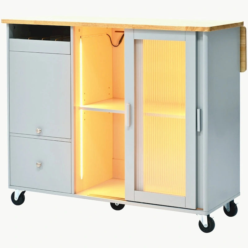 Carrello isola da cucina con piano a ribalta, illuminazione LED e ante in vetro scanalato su ruote