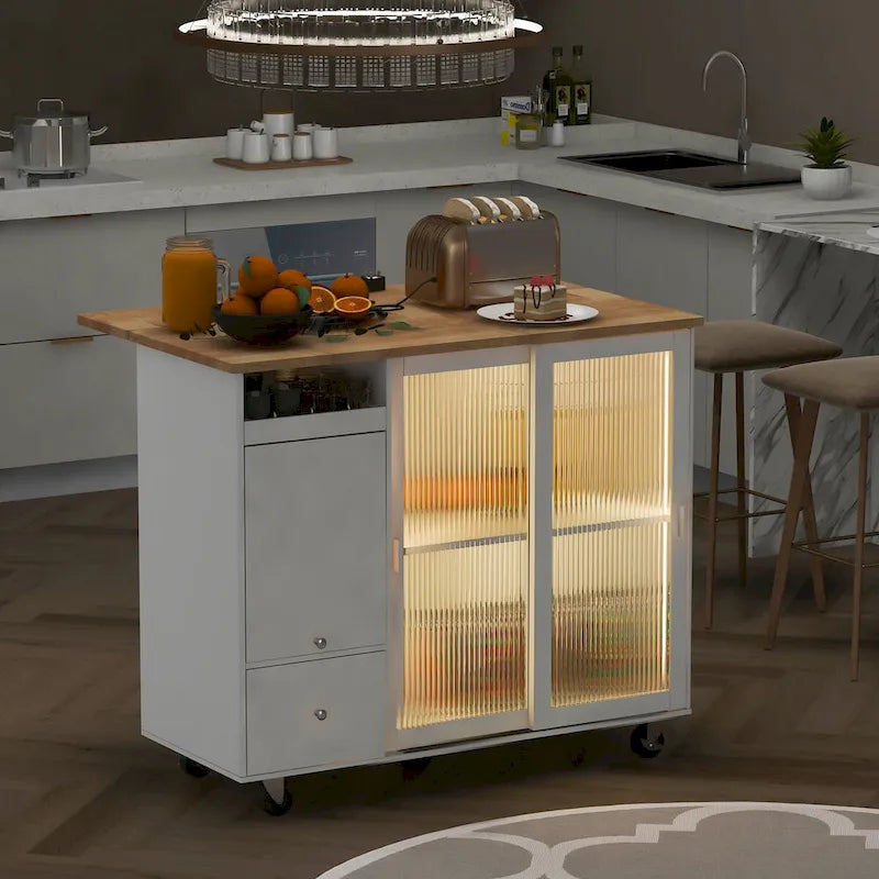 Carrello isola da cucina con piano ribaltabile, illuminazione LED, ante in vetro scanalato, ripiano regolabile e due cassetti